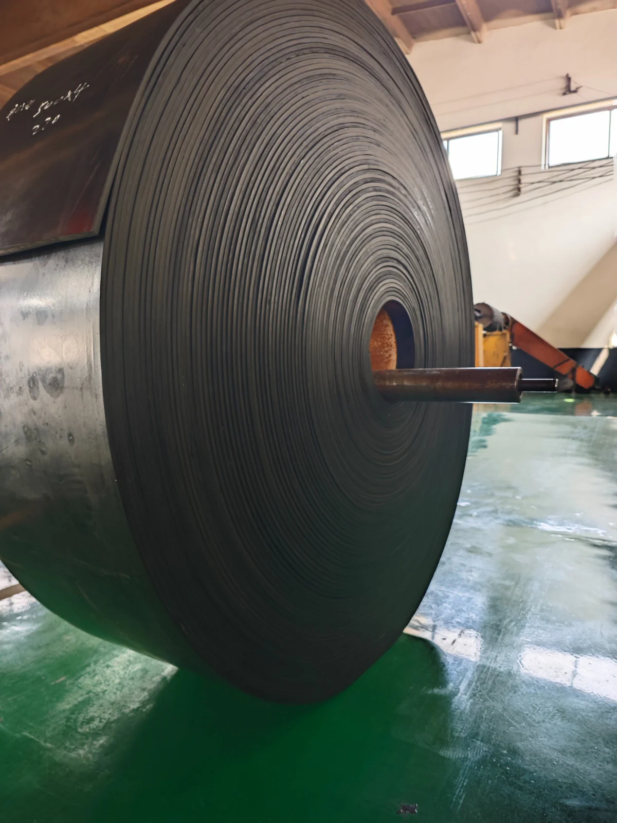 Large finished fabric conveyor belt roll inside Bada factory